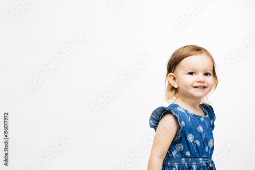 Portrait of a cute preschool girl smiling on white background
