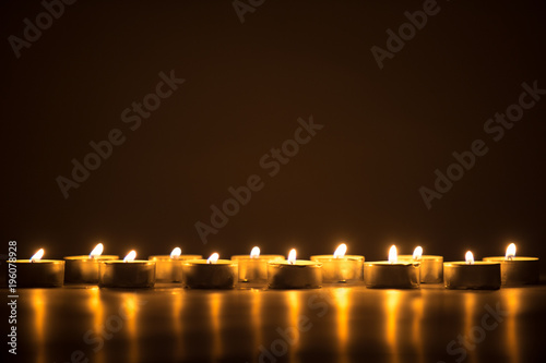 candle flames glowing in the dark.