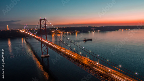 Bridge 25 de abril in Lisbon, Portugal. Aerial view at sunset.