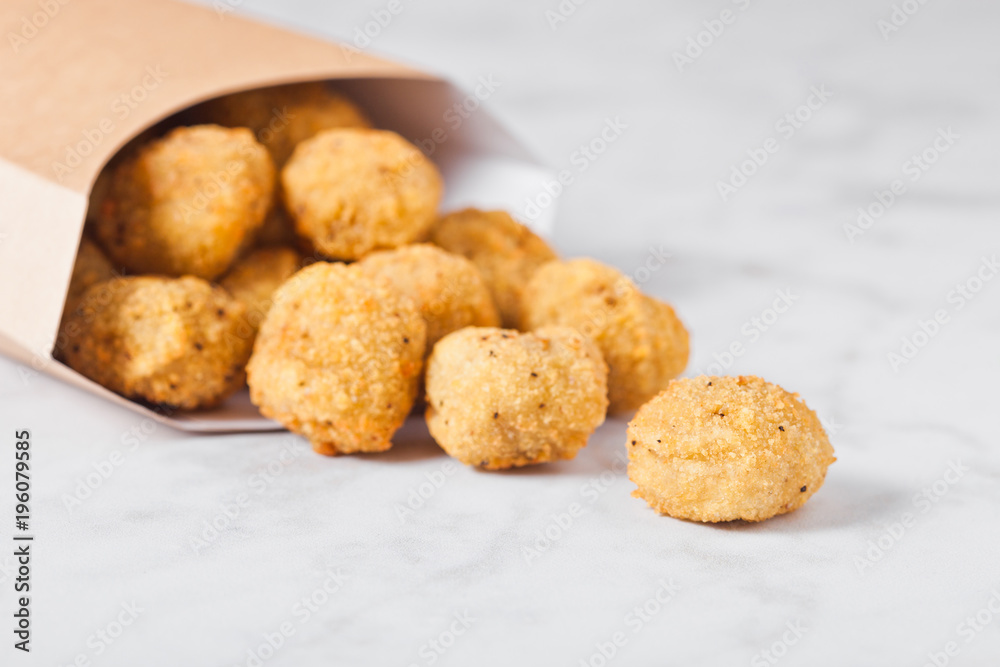 Paper container with fried crispy chicken popcorn
