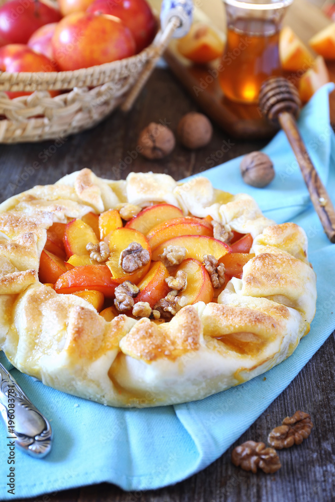 Homemade yellow plums and walnuts tart galette with walnuts and honey Homemade yellow plums and walnuts tart galette with walnuts and honey