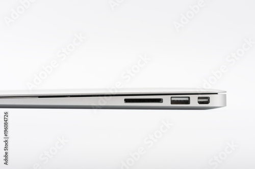 Part of modern new laptop on white background, close up, side view.