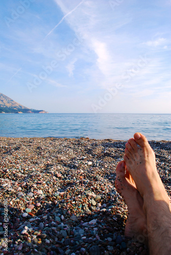 mens feet on beach, vacation tourism injoy concept photo