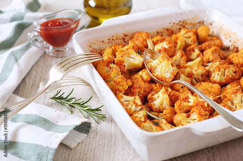 Vegetable vegetarian food: spicy roasted cauliflower in tomato sauce and olive oil photo