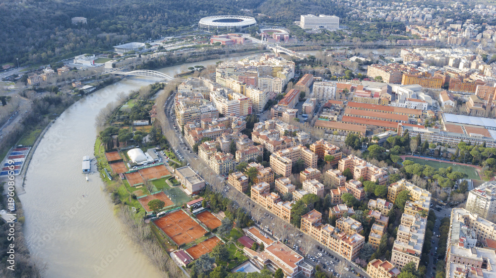 Aerial view of the Tiber in the northern part of Rome, Italy. In the background you can see the Olympic stadium and the italic forum. At the bottom of the red clay tennis courts.