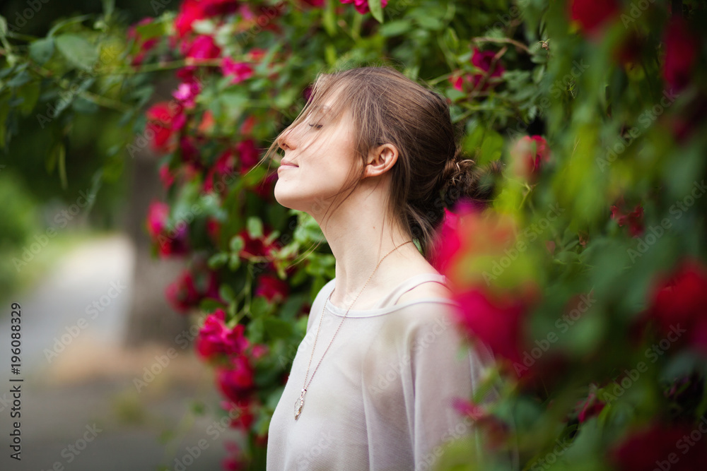 Beautiful tender woman in rose garden