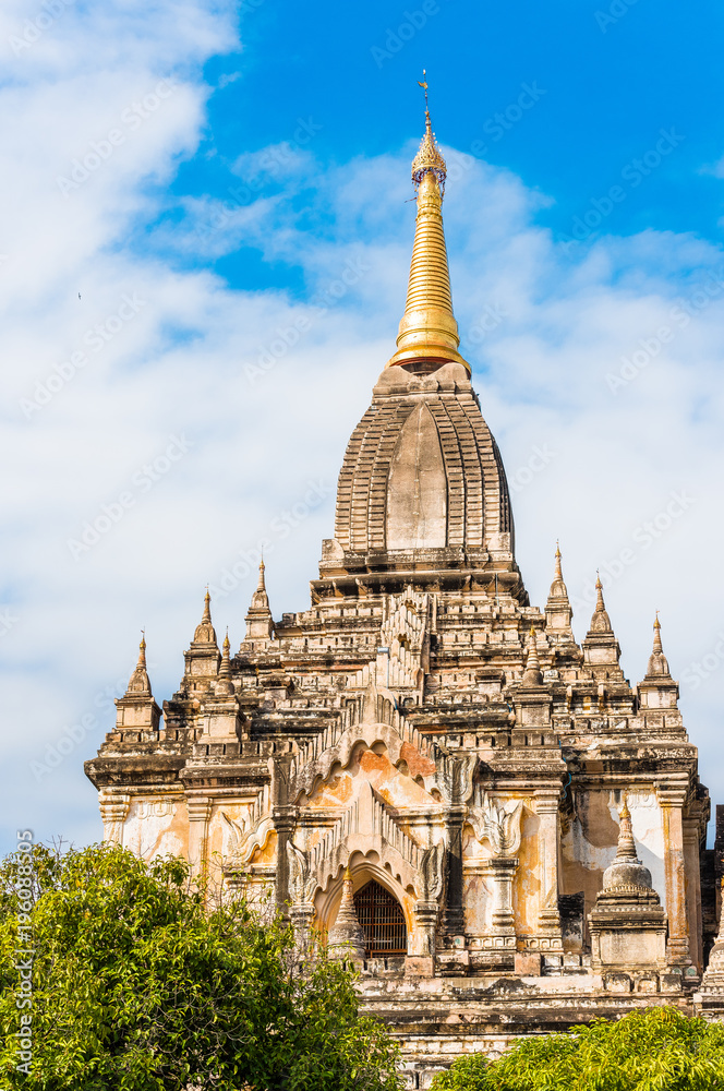 View of the facade of the building of the Shwegugyi temple in Bagan, Myanmar. Copy space for text. Vertical.