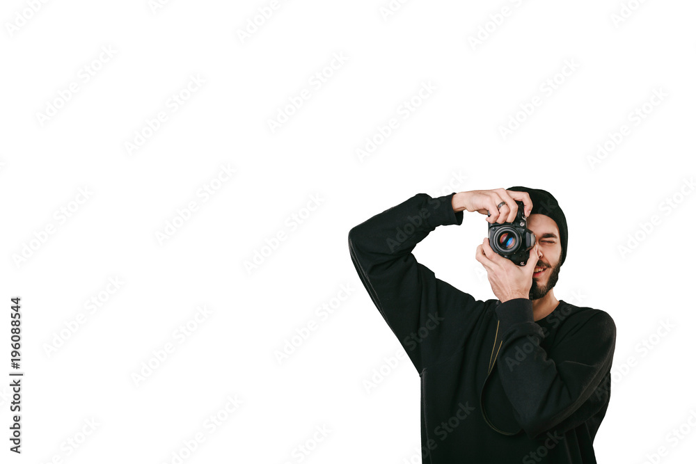 Stylish digital photographer with a beard in black shirt and casual hat. Isolated on white background, white place for your descripition concept. Stylish digital photographer with a beard in black shirt and casual hat. Isolated on white background, white place for your descripition concept.