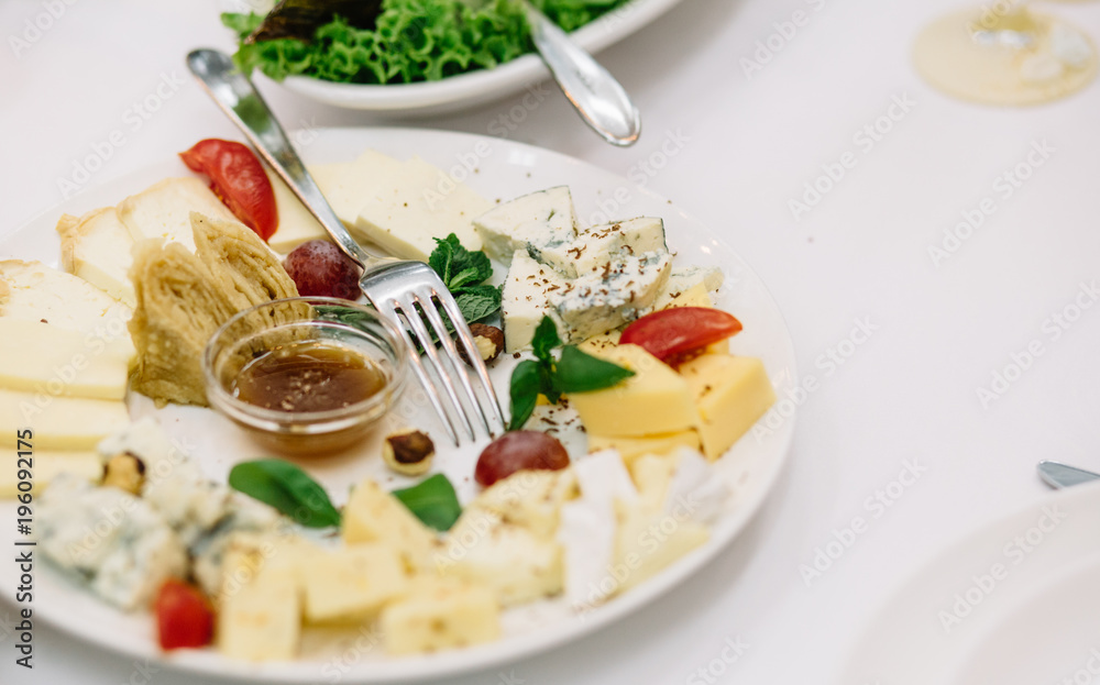Cheese plate. Delicious cheese on a wooden table. Cheese plate. Delicious cheese on a wooden table.