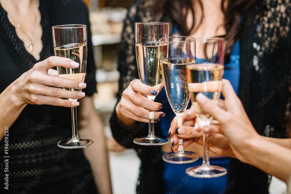 Group of partying girls clinking flutes with sparkling wine Group of partying girls clinking flutes with sparkling wine