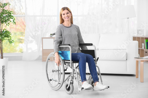 Young woman in wheelchair i...