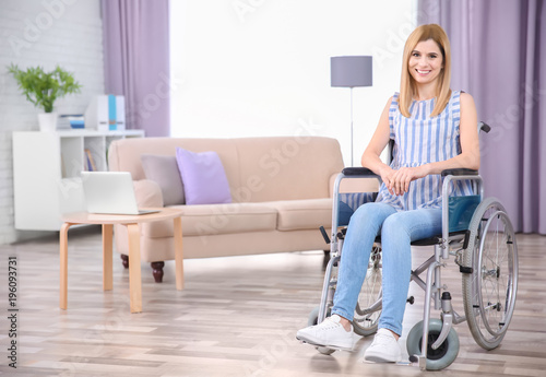 Young woman in wheelchair i...
