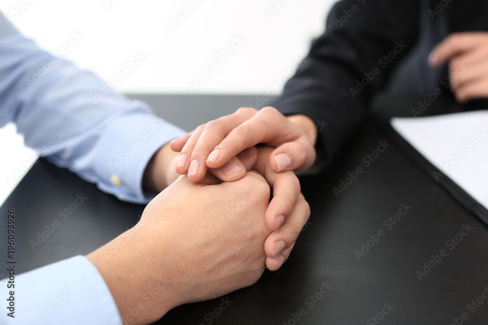 Lawyer having meeting with client in office, closeup