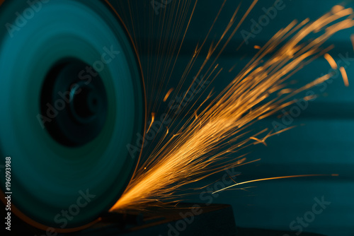 Close-up shot of an angle grinder with sparkles photo