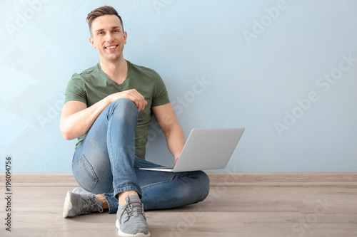 Young man using laptop indoors