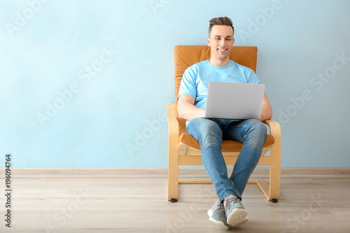 Young man using laptop indoors