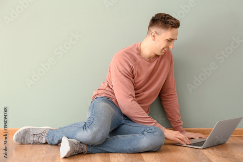 Young man using laptop indoors