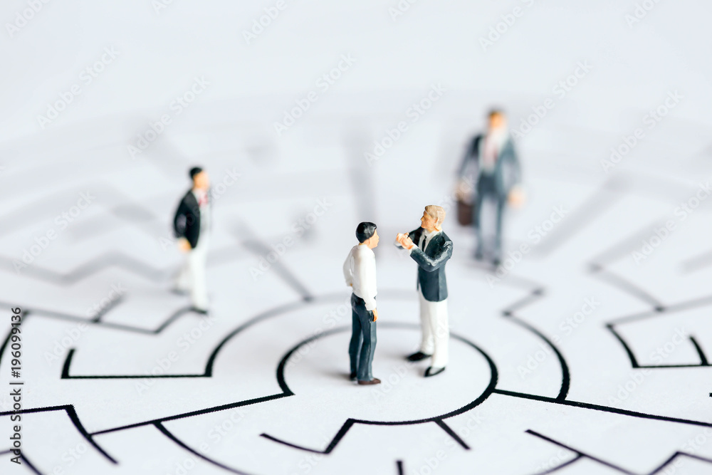 Miniature people : Businessman stand on maze ,business concept. Miniature people : Businessman stand on maze ,business concept.