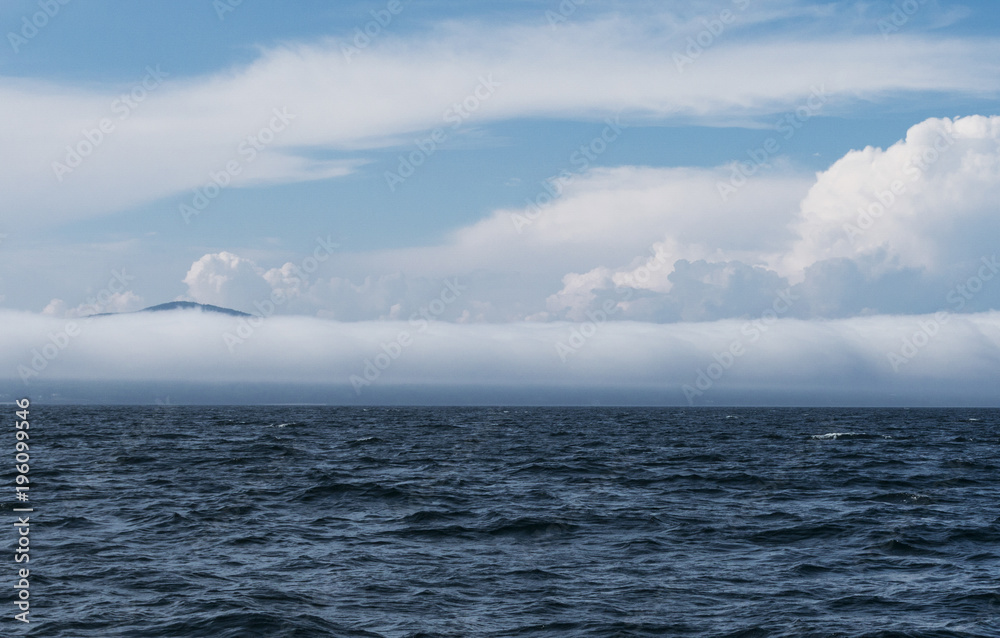 Extremely long barrel cloud covers the coast Extremely long barrel cloud covers the coast
