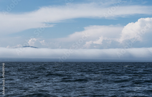 Extremely long barrel cloud covers the coast
