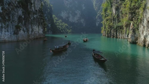 Tropical Thai jungle lake Cheo lan drone flight, wild mountains nature national park ship yacht