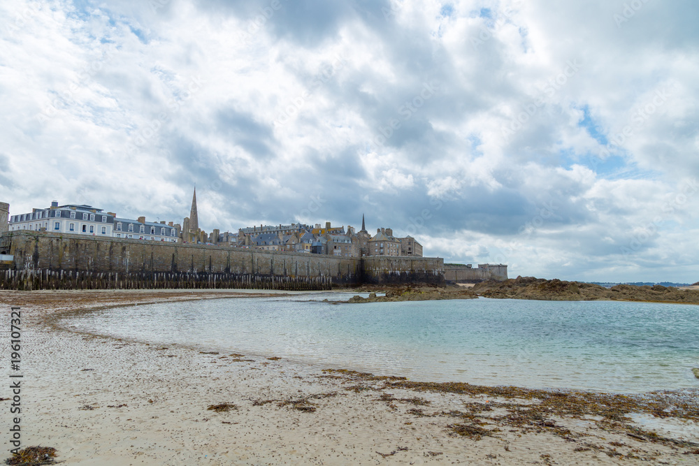 Saint Malo port city Brittany, Europe with the sea bay with clear water and heavy clouds. Typical weather