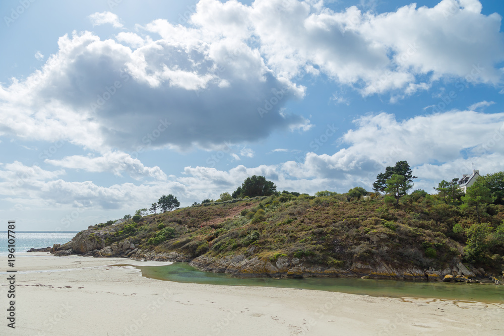 Panoramic of an European forest cliff and rocks on a estuary sea inlet with clear water and white sand
