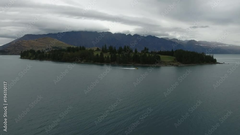 New Zealand Queenstown Fly Over Lake Towards Island with Speed Boat New Zealand Queenstown Fly Over Lake Towards Island with Speed Boat