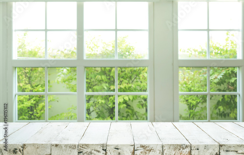 Top of wood table counter on blur window view garden background