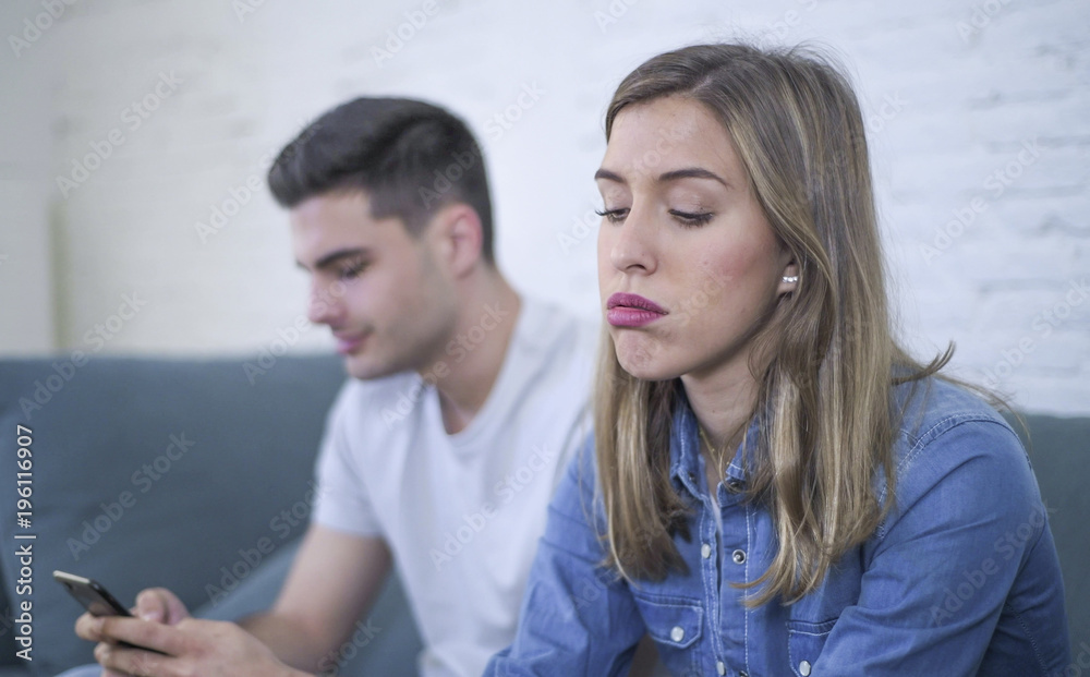 young attractive couple in relationship problem with internet mobile phone gambling addict boyfriend ignoring sad neglected and bored girlfriend young attractive couple in relationship problem with internet mobile phone gambling addict boyfriend ignoring sad neglected and bored girlfriend
