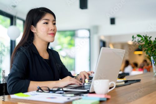 young businesswoman working with mobile laptop and documentsin office, business concept