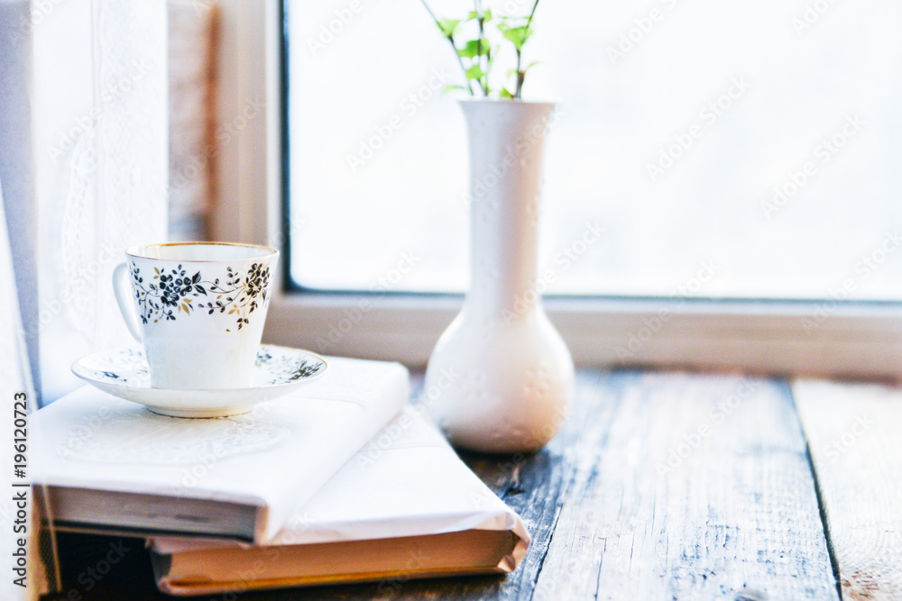 open book, coffee mug by the window, the concept of dreams and thoughtfulness open book, coffee mug by the window, the concept of dreams and thoughtfulness