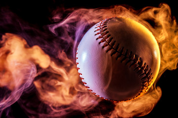 White baseball ball in multi-colored red smoke from a vape on a black isolated background