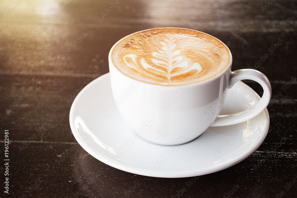 Cup of coffee with latte art on wooden table background Cup of coffee with latte art on wooden table background