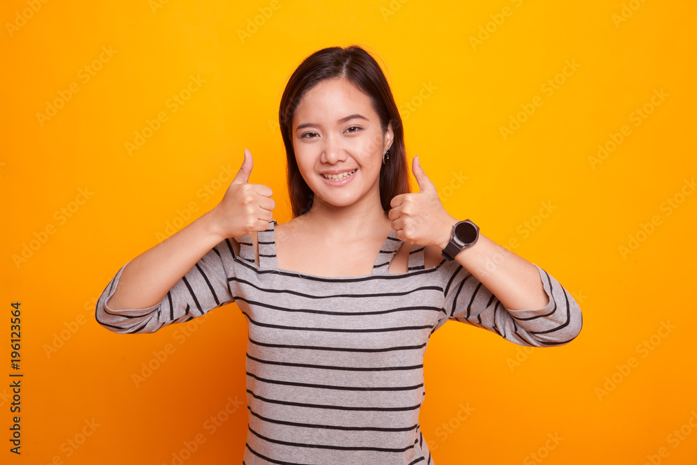Young Asian woman show two thumbs up. Young Asian woman show two thumbs up.