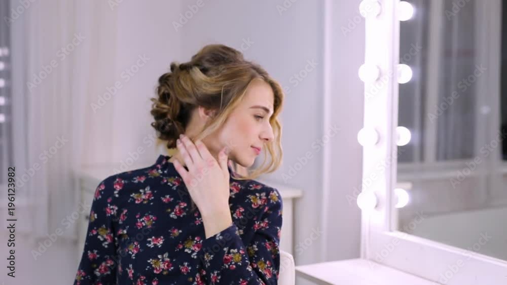 beautiful young woman with hairstyle in front of mirror beautiful young woman with hairstyle in front of mirror