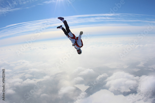 Skydiver is flying in the winter sky.