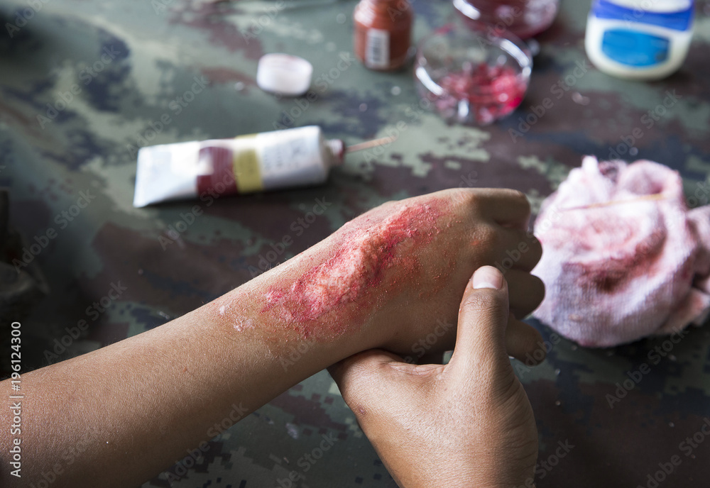 Fototapeta premium make up scar process on hand in war cinema industry