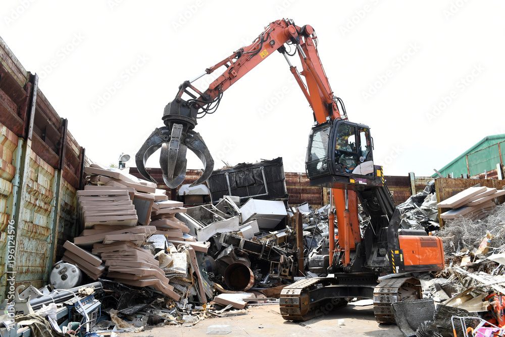 Fototapeta premium Excavator is loading scrap Industrial waste. 