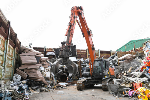 Excavator is loading scrap Industrial waste. 