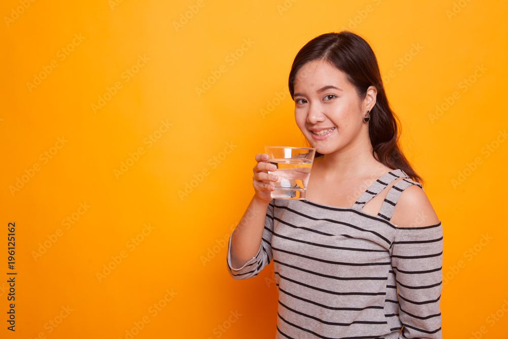 Young Asian woman with a glass of drinking water. Young Asian woman with a glass of drinking water.