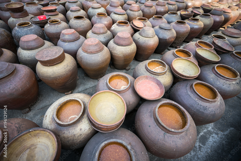 Jars of processing soybean jam made by traditional outdoor way under natural sunlight Jars of processing soybean jam made by traditional outdoor way under natural sunlight
