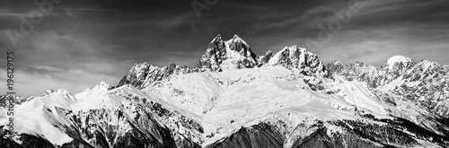 Black and white panoramic view on Mount Ushba at wind sunny day