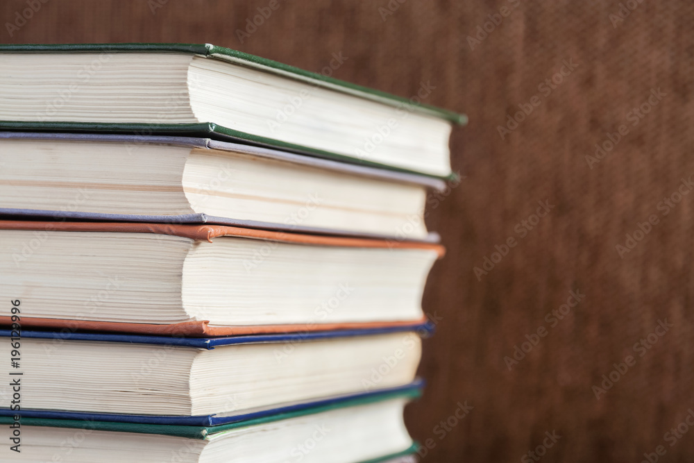 Pile of old books on brown background. Closeup, selective focus. Pile of old books on brown background. Closeup, selective focus.