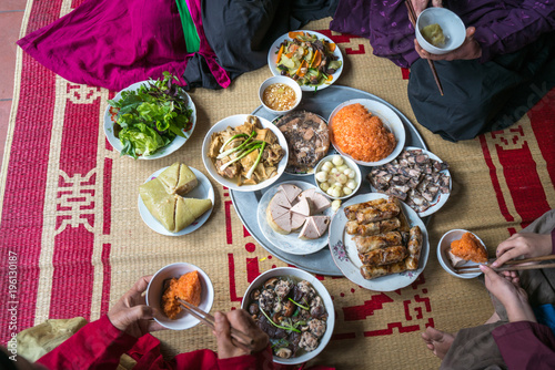 A traditional Vietnamese meal for lunar new year Tet holiday in spring, placed on new flowered sedge mat, on the last day of the last year