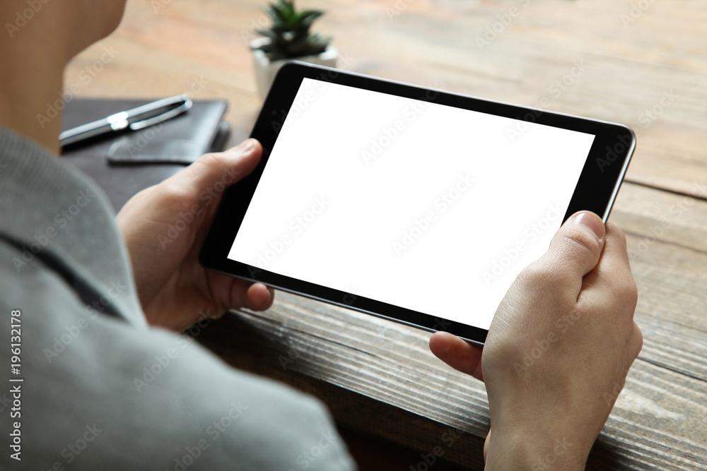 A modern tablet in the hands of a guy A modern tablet in the hands of a guy