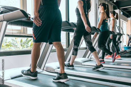 Row of people exercising on treadmills