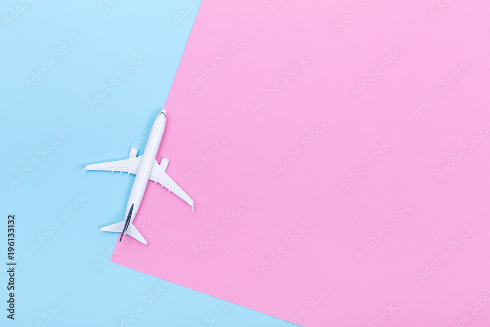 White blank model of passenger airplane on pastel colored paper texture White blank model of passenger airplane on pastel colored paper texture
