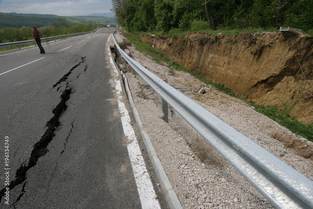 Road collapses with huge cracks. International road collapsed down after bad construction. Damaged Highway Road. Asphalt road collapsed and fallen. Erosion. 