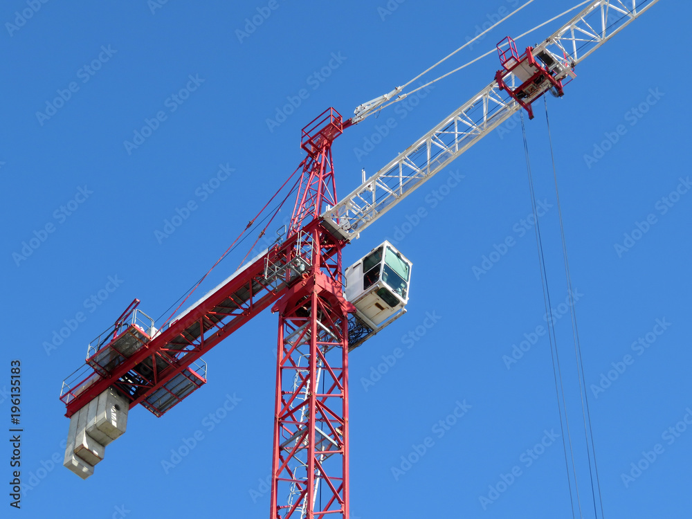 Construction crane on the background of clear blue sky